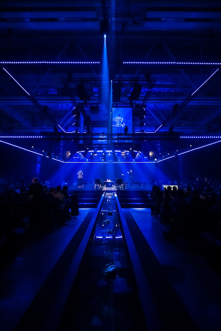 a blue light shines in the middle of a dark room